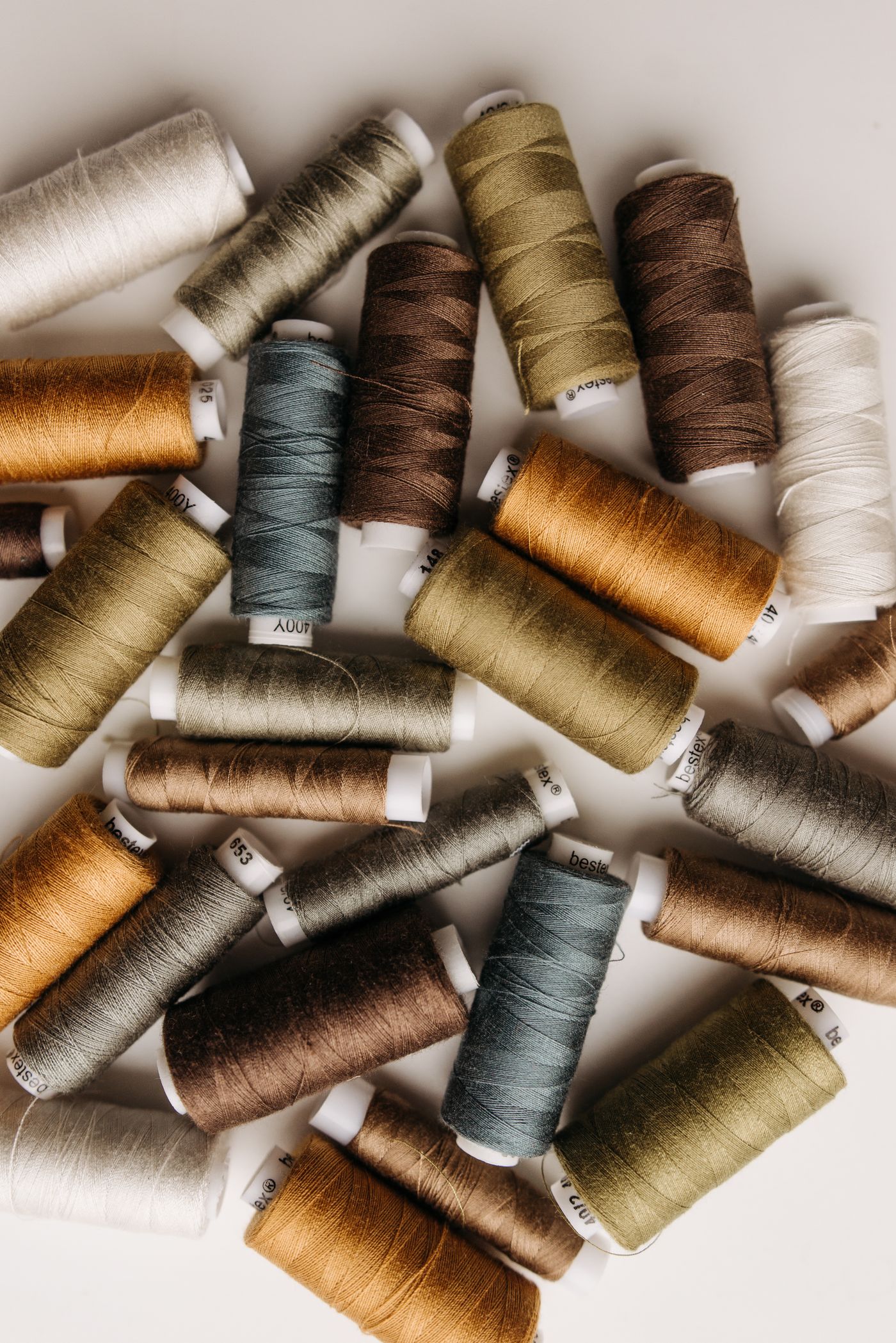Spools of sewing thread in muted earth colours